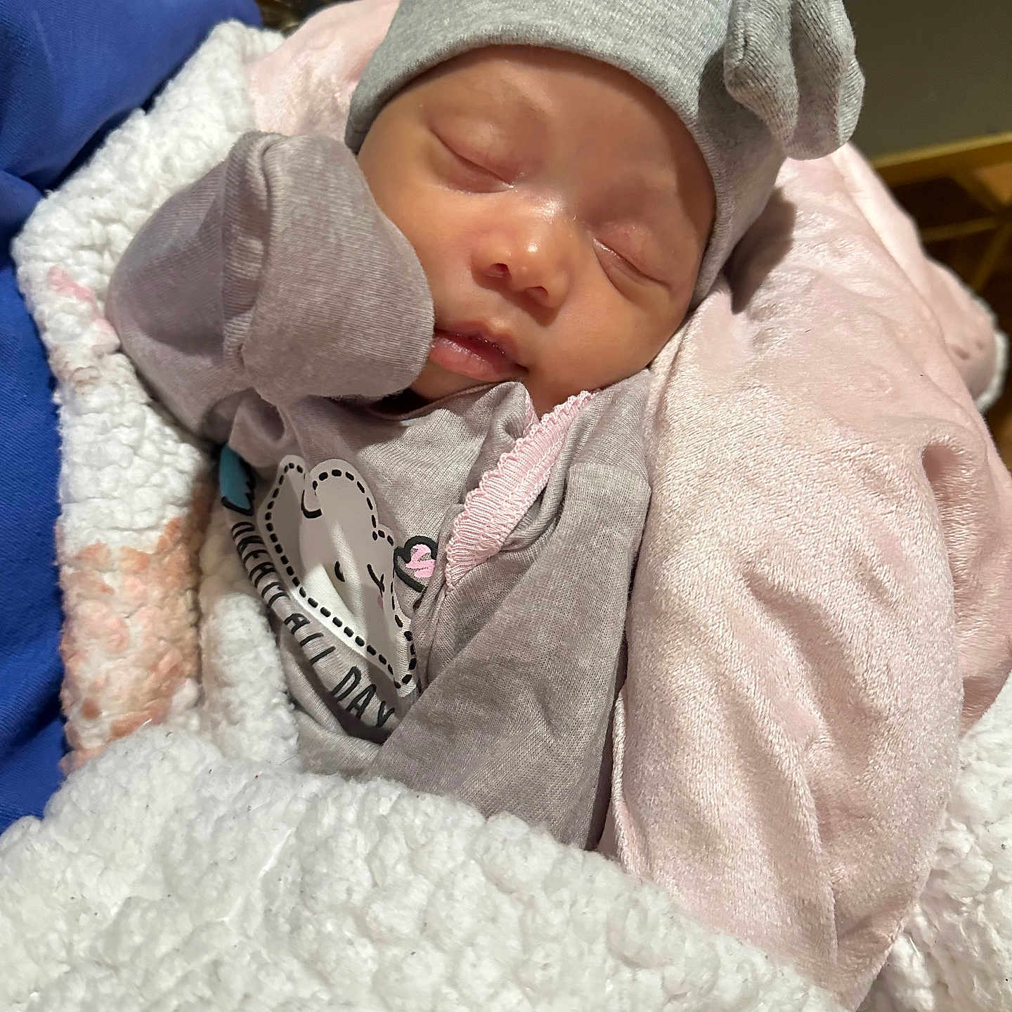 Iselynn is registered to the contest to win money with this photo: baby, blanket, bonnet, cap, clothing, face, glove, hat, head, hoodie, knitwear, newborn, person, photography, portrait, quilt, sleeping, sweater, sweatshirt, towel