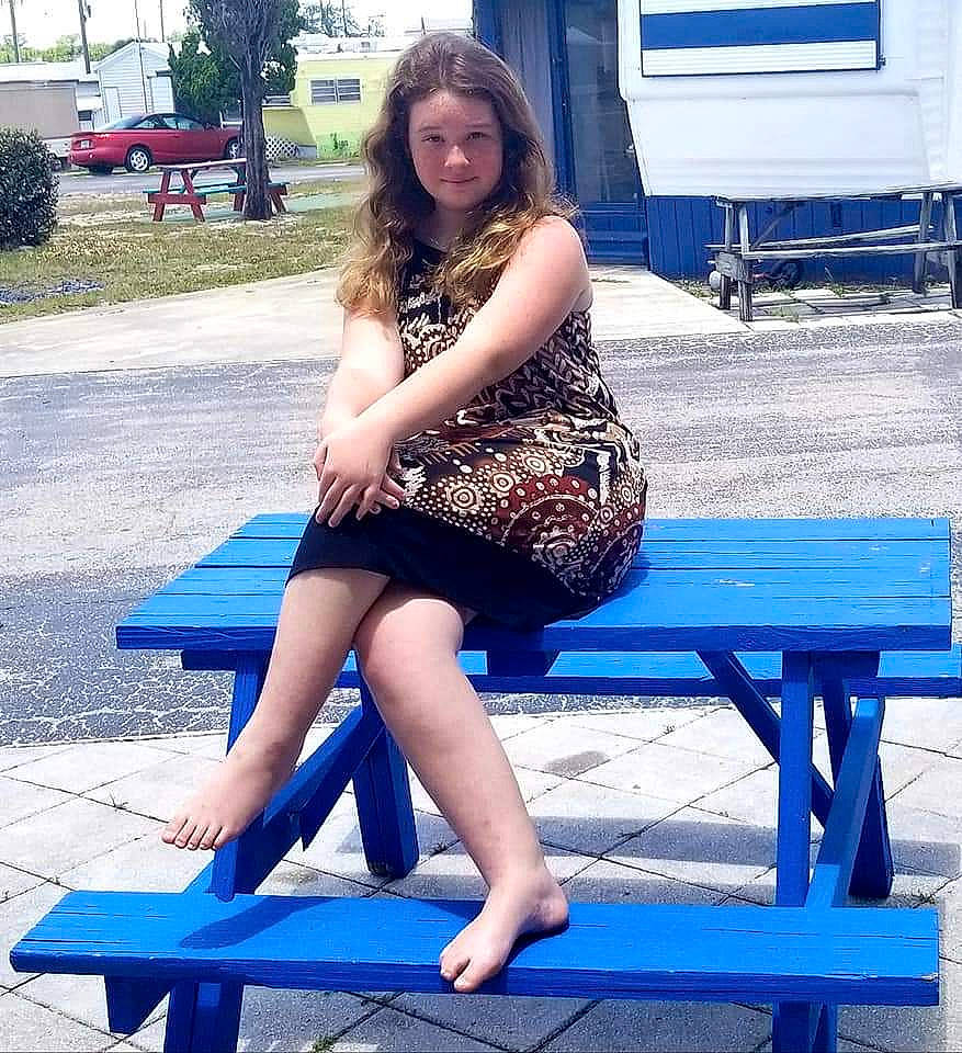 Karene is registered to the contest to win money with this photo: beauty, bench, blue, dress, electric_blue, fashion, furniture, human_body, human_leg, leg, long_hair, person, picnic_table, sitting, smile, snapshot, summer, table, thigh, tree