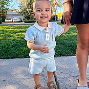 Kashus joined the competition — help win amazing prizes! toddler, child, person, smiling, outdoor, sidewalk, grass, trees, stop_sign, car, summer_clothing, sandals, holding_hand, adult, blue_outfit, sunny, suburban, happy, portrait, nature
