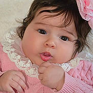 Ashley joined the competition — help win amazing prizes! baby, child, face, portrait, pink_clothing, lace, headband, flower, cute, chubby_cheeks, hand, infant, soft_light, closeup, adorable, young_child, skin, dark_hair, expression, indoor
