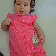 Ashley is registered to the contest to win money with this photo: baby, infant, girl, pink, bows, romper, polka_dot, bed, white, cute, expression, hair, socks, footwear, indoor, child, smiling_patch, sleepwear, lying_down, curious
