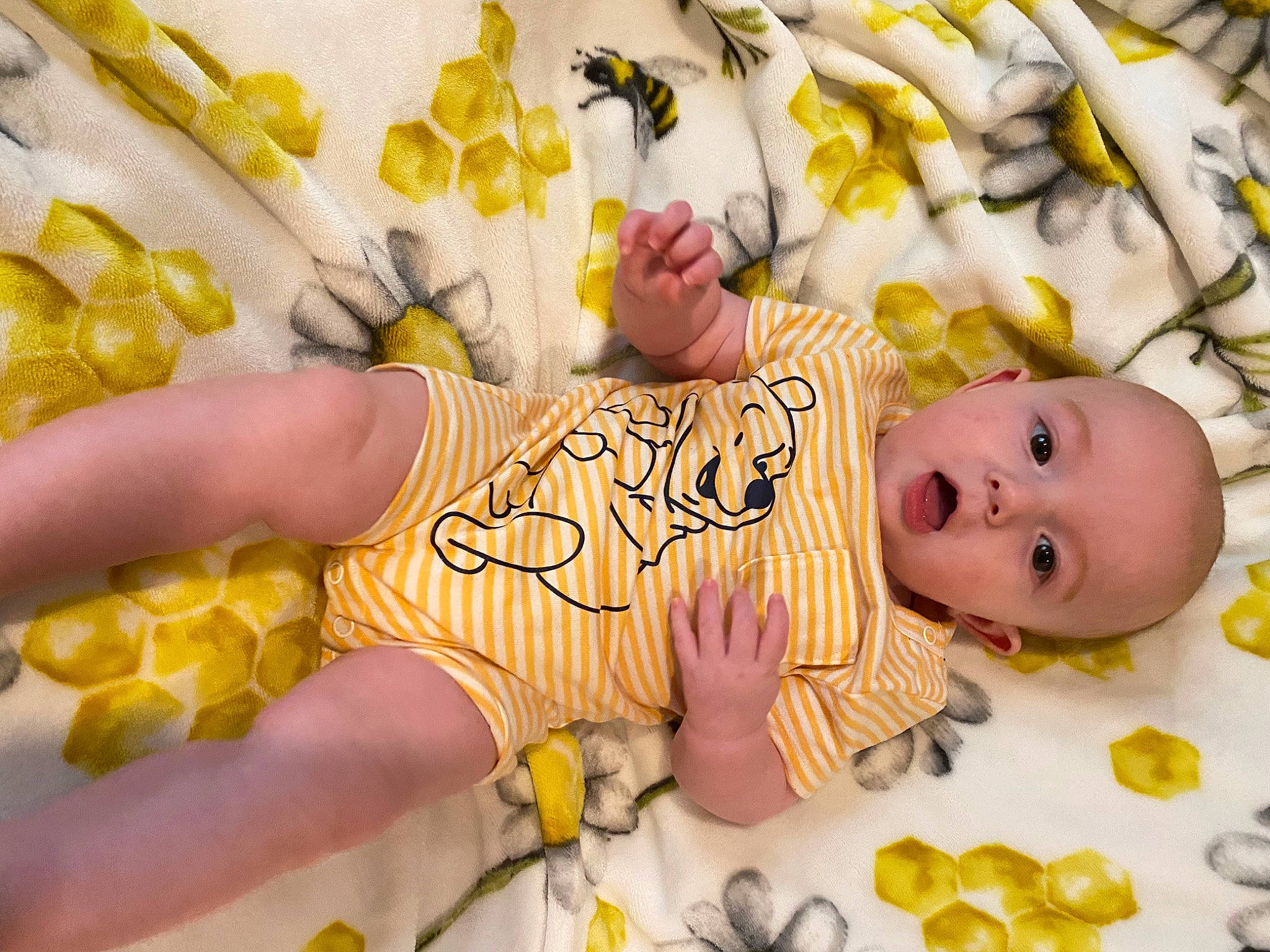 Eli is registered to the contest to win money with this photo: arm, baby, baby_products, baby_toddler_clothing, cheek, child, comfort, finger, hand, happy, linens, nail, pattern, person, skin, surprise, sweetness, textile, thumb, toddler