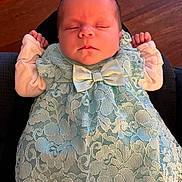 Allison joined the competition — help win amazing prizes! baby, newborn, sleeping, dress, lace, bow, infant, clothing, portrait, peaceful, resting, hands, cute, indoors, wood_floor, person, soft_light, closeup, tiny, adorable