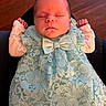 baby, newborn, sleeping, dress, lace, bow, infant, clothing, portrait, peaceful, resting, hands, cute, indoors, wood_floor, person, soft_light, closeup, tiny, adorable