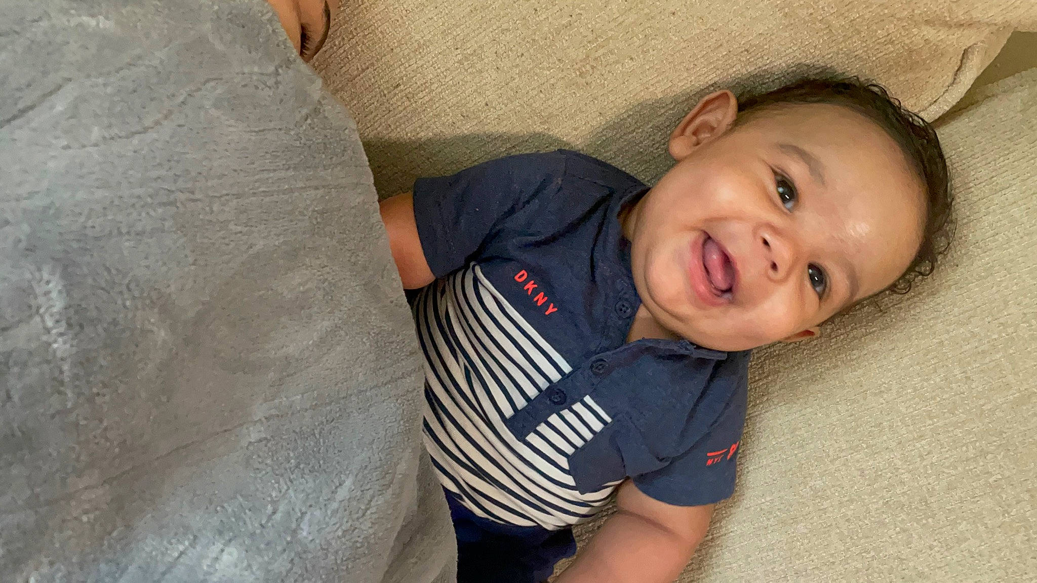 Brycen is registered to the contest to win money with this photo: arm, baby, baby_toddler_clothing, cheek, comfort, elbow, eye, face, facial_expression, flash_photography, happy, iris, lip, mouth, nose, person, skin, sleeve, smile, t_shirt