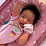 baby, smiling, pink, mittens, polka_dot, cushion, infant, cute, happy, lying_down, clothing, face, portrait, soft_toys, indoors, child, sweetie, ice_cream, striped, handwear