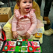 Renesmea is registered to the contest to win money with this photo: toddler, child, smiling, pink_dress, plush_chair, gift_wrap, boxes, winnie_the_pooh, indoor, carpet, happy, person, sitting, clothing, floor, toy, cute, portrait, celebration, holiday