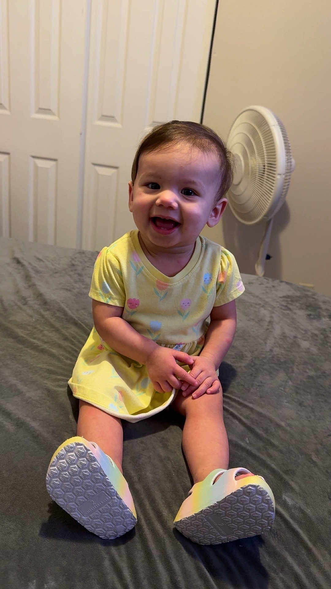 Madeleine joined the competition — help win amazing prizes! toddler, child, smiling, yellow_dress, sitting, bed, colorful_shoes, indoor, fan, closet, happy, person, short_hair, cute, playful, young_child, furniture, home, portrait, casual