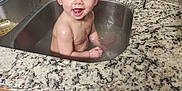 Madeleine joined the competition — help win amazing prizes! baby, sink, bath, water, kitchen, countertop, smile, happy, child, face, wet, cabinet, tap, cleaning_brush, household, indoor, person, cute, playful, curious