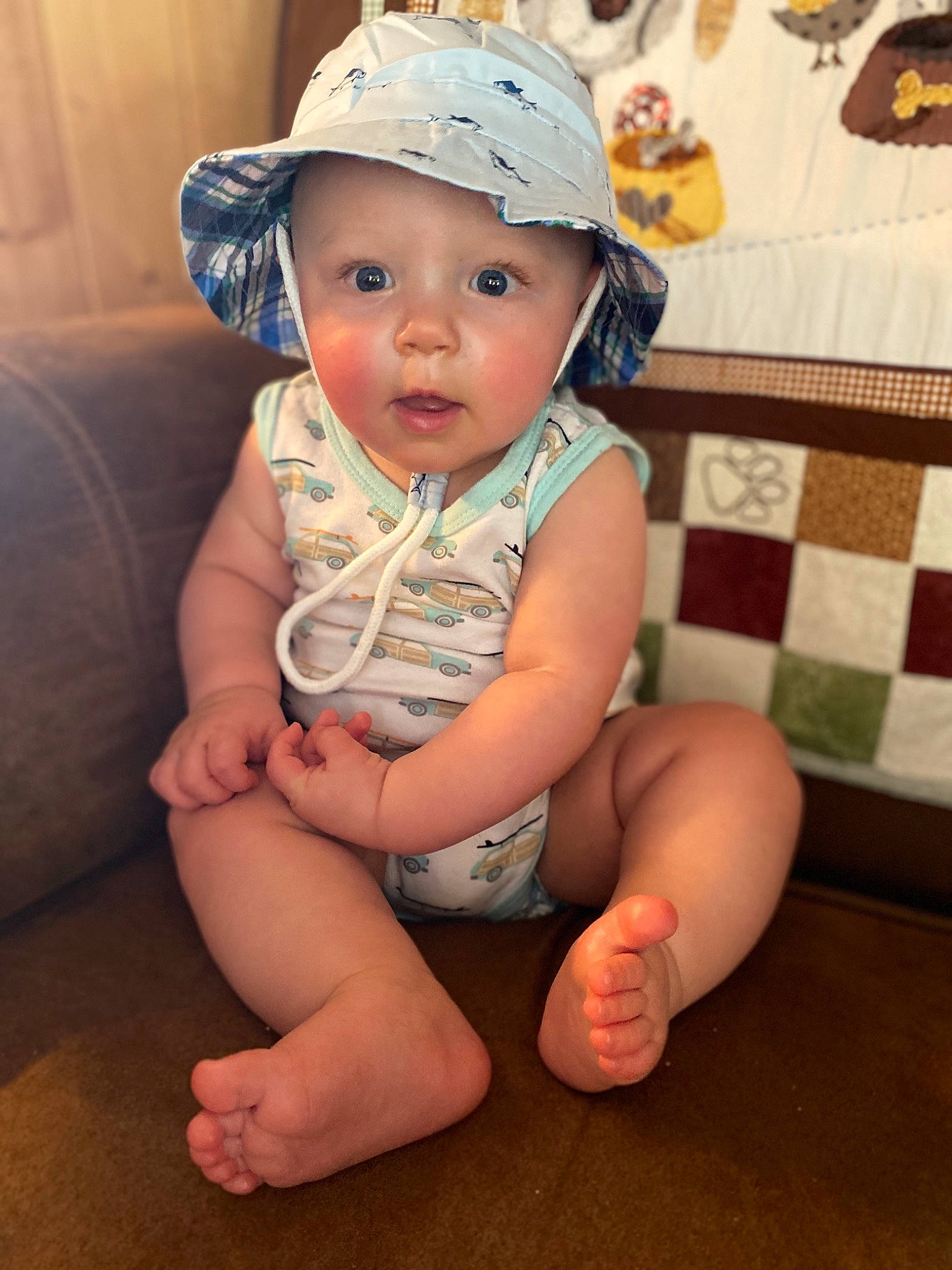 Issac joined the competition — help win amazing prizes! baby, baby_toddler_clothing, cap, cheek, child, fashion_accessory, floor, flooring, fun, hand, hat, headgear, headwear, leg, person, sitting, skin, smile, sun_hat, toddler