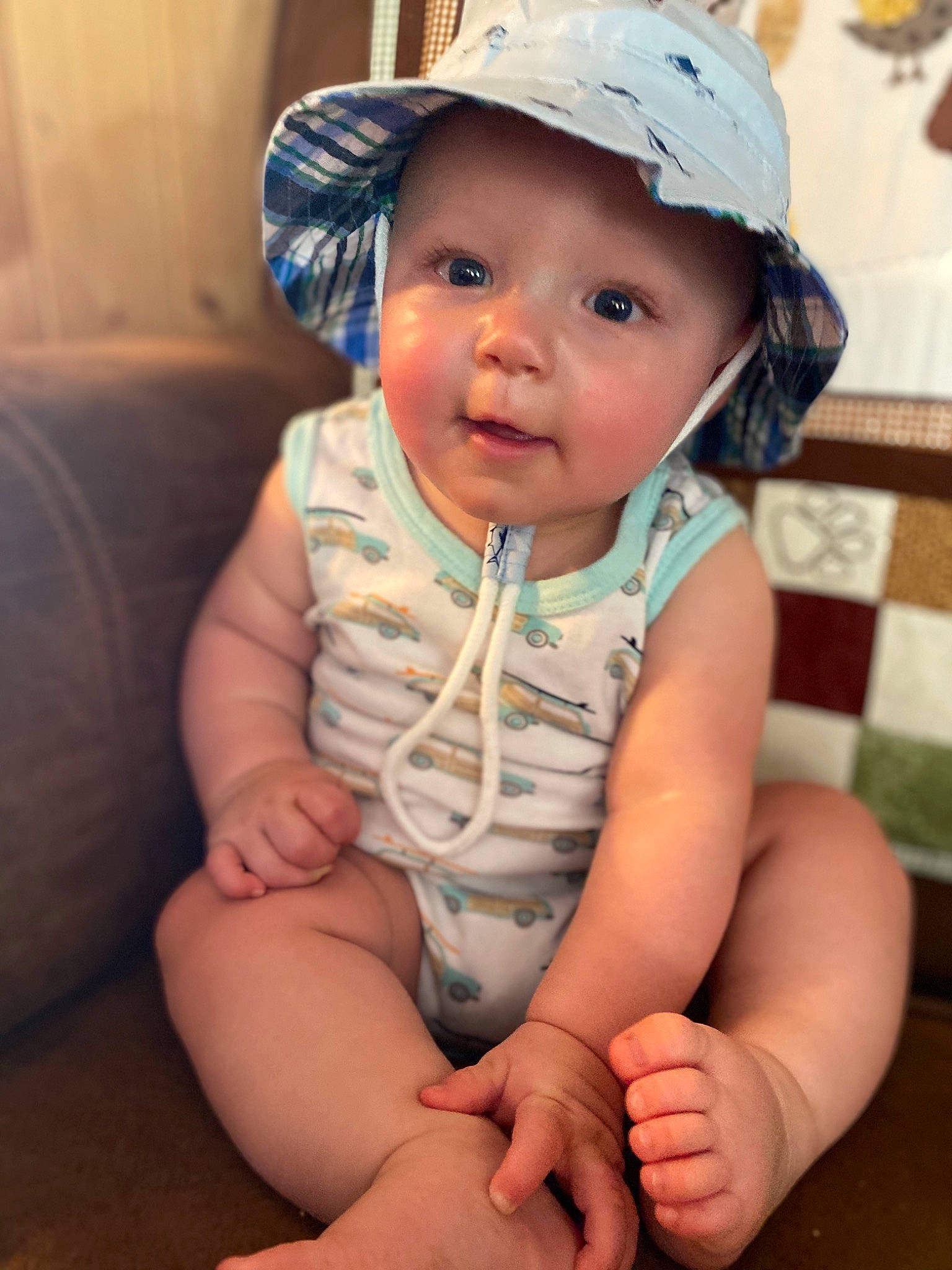 Issac is registered to the contest to win money with this photo: baby, baby_toddler_clothing, cap, cheek, child, eye, fashion_accessory, hand, hat, head, headgear, headwear, leg, person, sitting, skin, smile, sun_hat, toddler, vacation