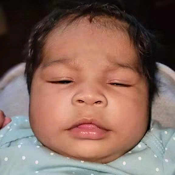 Jazmyn is registered to the contest to win money with this photo: baby, infant, face, chubby_cheeks, blue_clothing, polka_dot, close_up, calm, relaxed, soft_background, person, cute, child, young, portrait, indoors, skin, head, hair, newborn