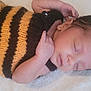 Hugo joined the competition — help win amazing prizes! baby, sleeping, infant, knitted_outfit, striped, black, yellow, hand, face, peaceful, soft_blanket, cute, newborn, portrait, lying_down, cozy, child, skin, hair, button