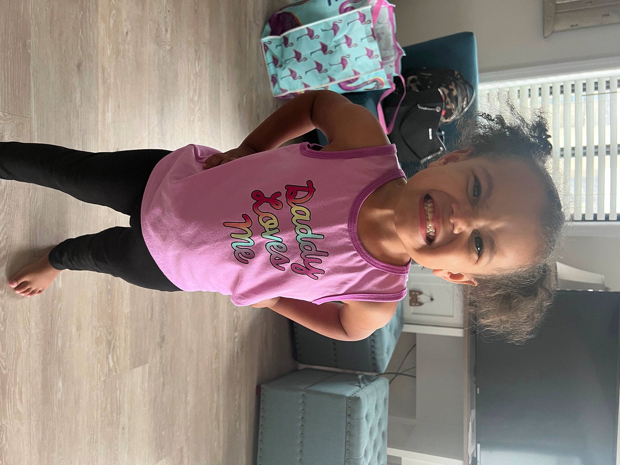 Caylee is registered to the contest to win money with this photo: child, elbow, eyewear, fun, happy, human_leg, joy, magenta, pattern, person, pink, purple, room, shoulder, sleeve, smile, t_shirt, thigh, toddler, top