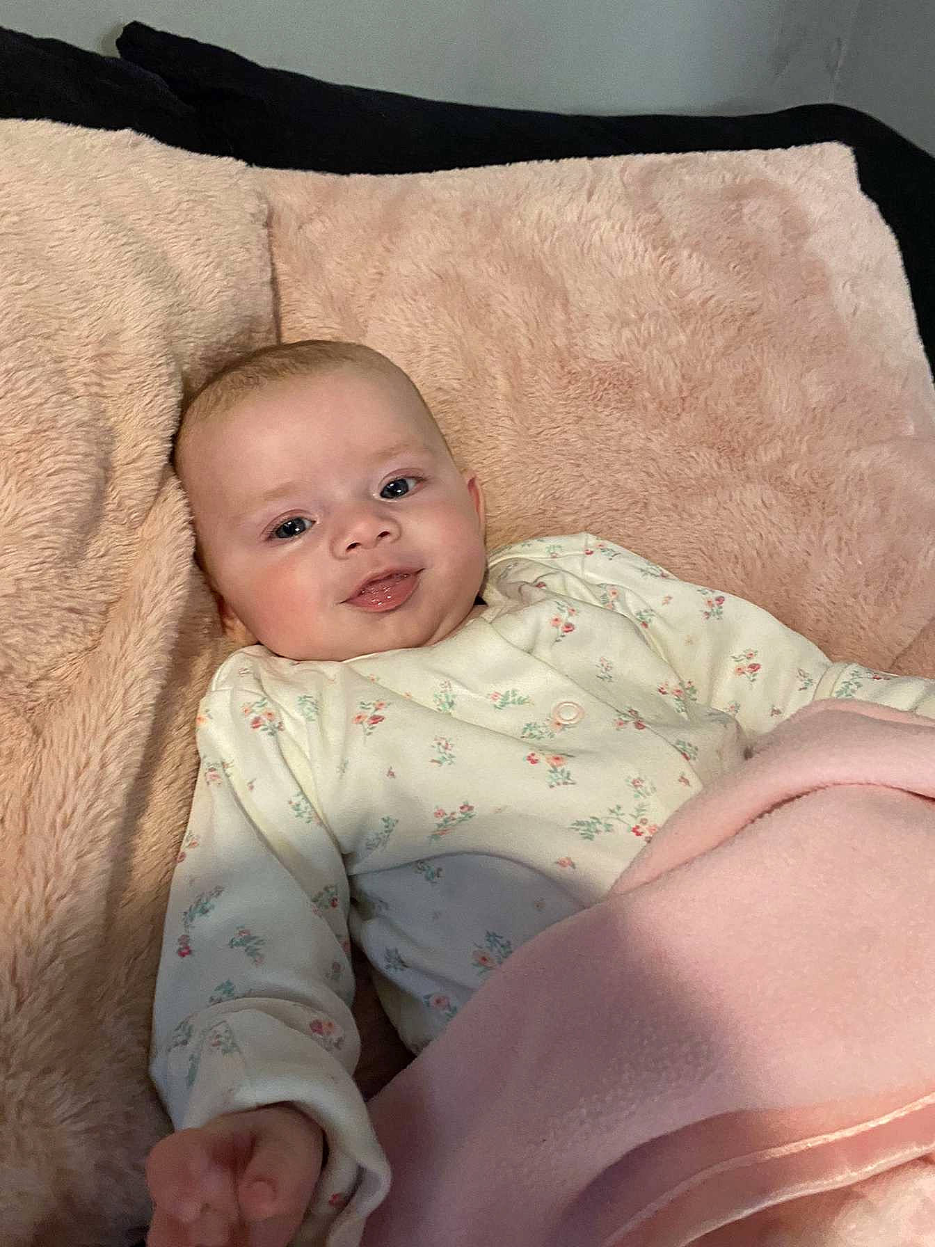 Esme is registered to the contest to win money with this photo: baby, baby_products, baby_sleeping, baby_toddler_clothing, bedding, cheek, child, chin, collar, comfort, linens, mammal, pattern, person, sitting, skin, sleeve, smile, stomach, textile