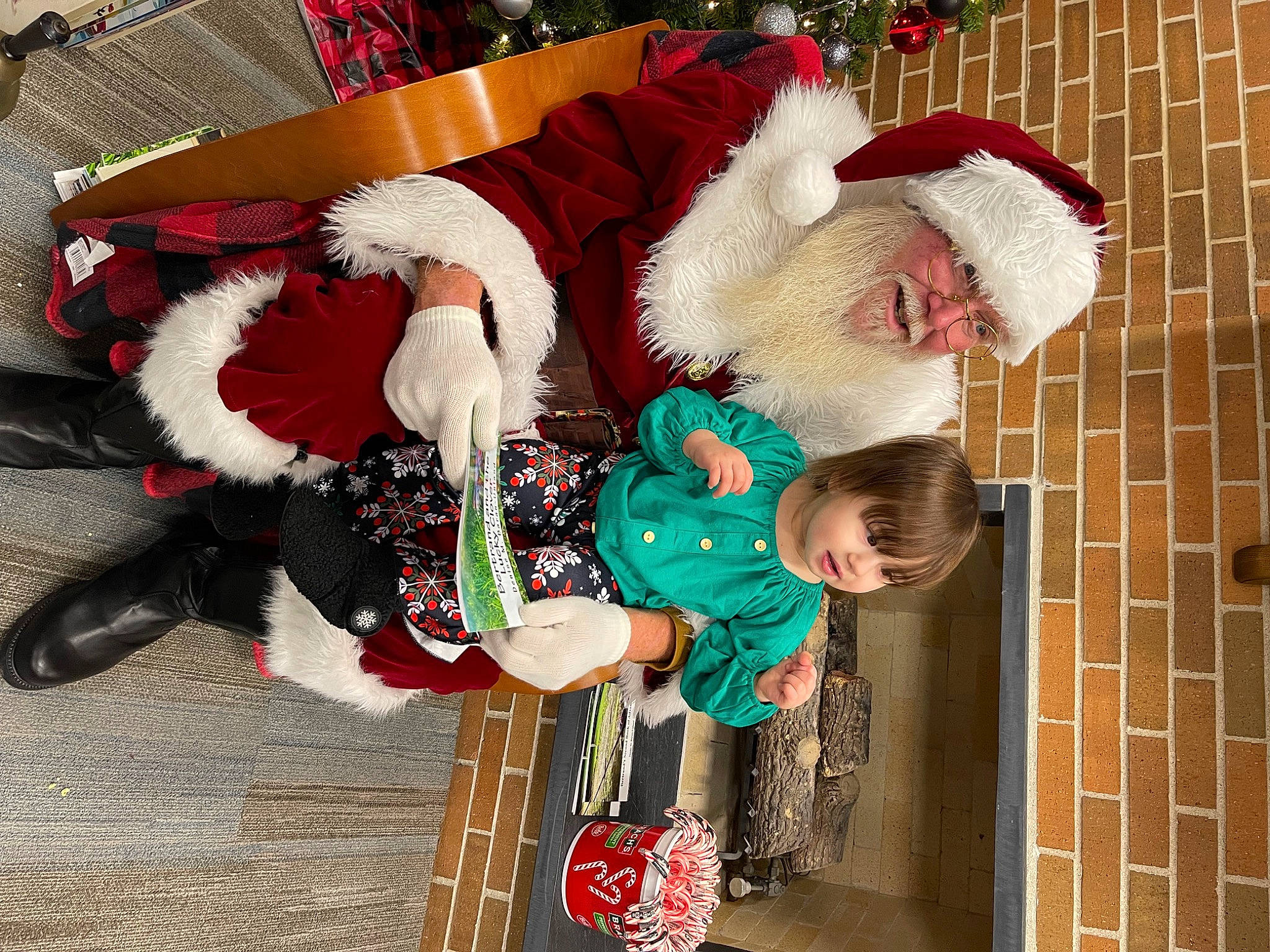 Kiara joined the competition — help win amazing prizes! carmine, child, christmas, christmas_decoration, christmas_eve, christmas_ornament, event, fictional_character, fun, fur, happy, headwear, holiday, interior_design, lap, person, red, santa_claus, toddler, tradition