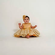 Alexandra is registered to the contest to win money with this photo: baby, child, dress, golden, lace, headband, smile, sitting, portrait, cute, elegant, fashion, studio, infant, adorable, young, girl, isolated, background, happy