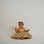 baby, child, dress, golden, lace, headband, smile, studio, portrait, sitting, cute, innocent, fashion, elegant, white_background, floor, barefoot, person, indoor, photography