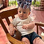 Raelynn joined the competition — help win amazing prizes! baby, child, football, chair, wooden_chair, bow, headwear, white_shirt, denim_shorts, outdoor, porch, curious, sitting, hand, face, legs, cute, infant, natural_light, expression