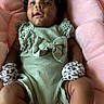 Malia is registered to the contest to win money with this photo: baby, infant, child, mint_green, bow, mittens, leopard_print, plush, cushion, pink, soft, cute, lying_down, indoors, portrait, apparel, fabric, skin, face, hands