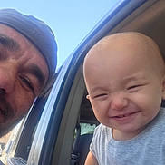 Camille joined the competition — help win amazing prizes! baby, child, man, beanie, car, window, smile, happy, outdoor, sky, face, person, vehicle, casual, portrait, cute, joy, headwear, expression, family