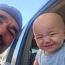 baby, child, man, beanie, car, window, smile, happy, outdoor, sky, face, person, vehicle, casual, portrait, cute, joy, headwear, expression, family