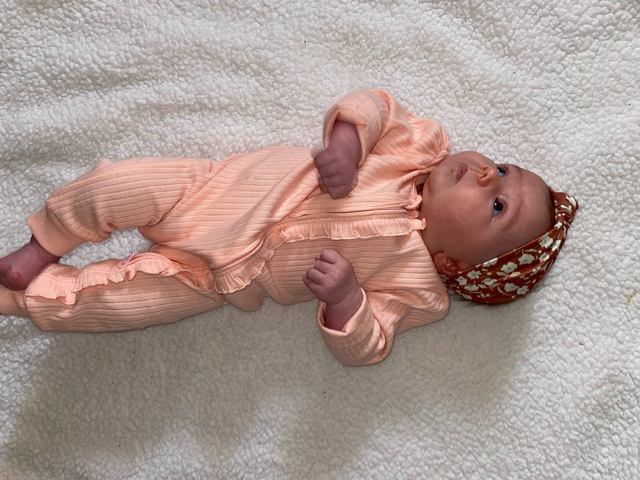 Kahlia is registered to the contest to win money with this photo: baby, baby_products, baby_toddler_clothing, child, comfort, fashion_accessory, flooring, hand, headgear, headwear, jewellery, linens, nail, peach, person, personal_protective_equipment, sitting, skin, toddler, wood