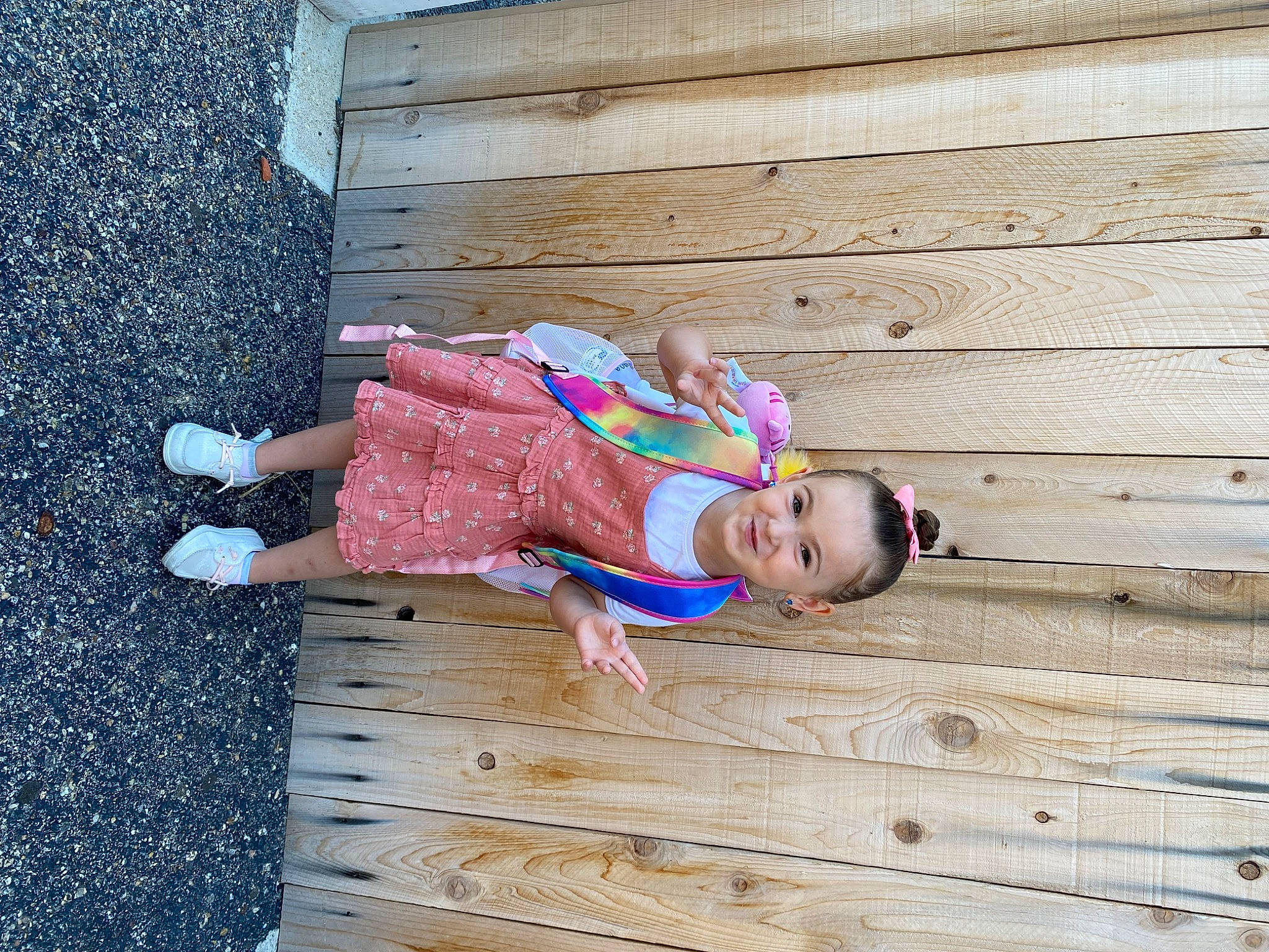 Lilliana is registered to the contest to win money with this photo: baby_toddler_clothing, child, electric_blue, flooring, fun, grass, happy, hardwood, joy, leisure, lumber, magenta, pattern, people_in_nature, person, plank, road_surface, sitting, toddler, tree