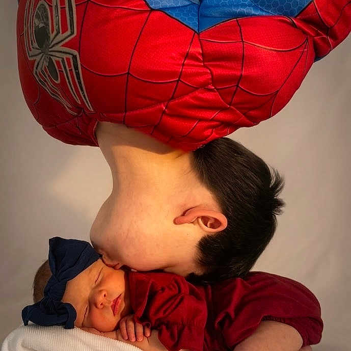 Mahayla is registered to the contest to win money with this photo: child, baby, sleeping_baby, spiderman_costume, red_clothing, blue_bow, headband, kiss, affection, family, portrait, cute, toddler, infant, soft_blanket, studio, love, bond, skin, hair
