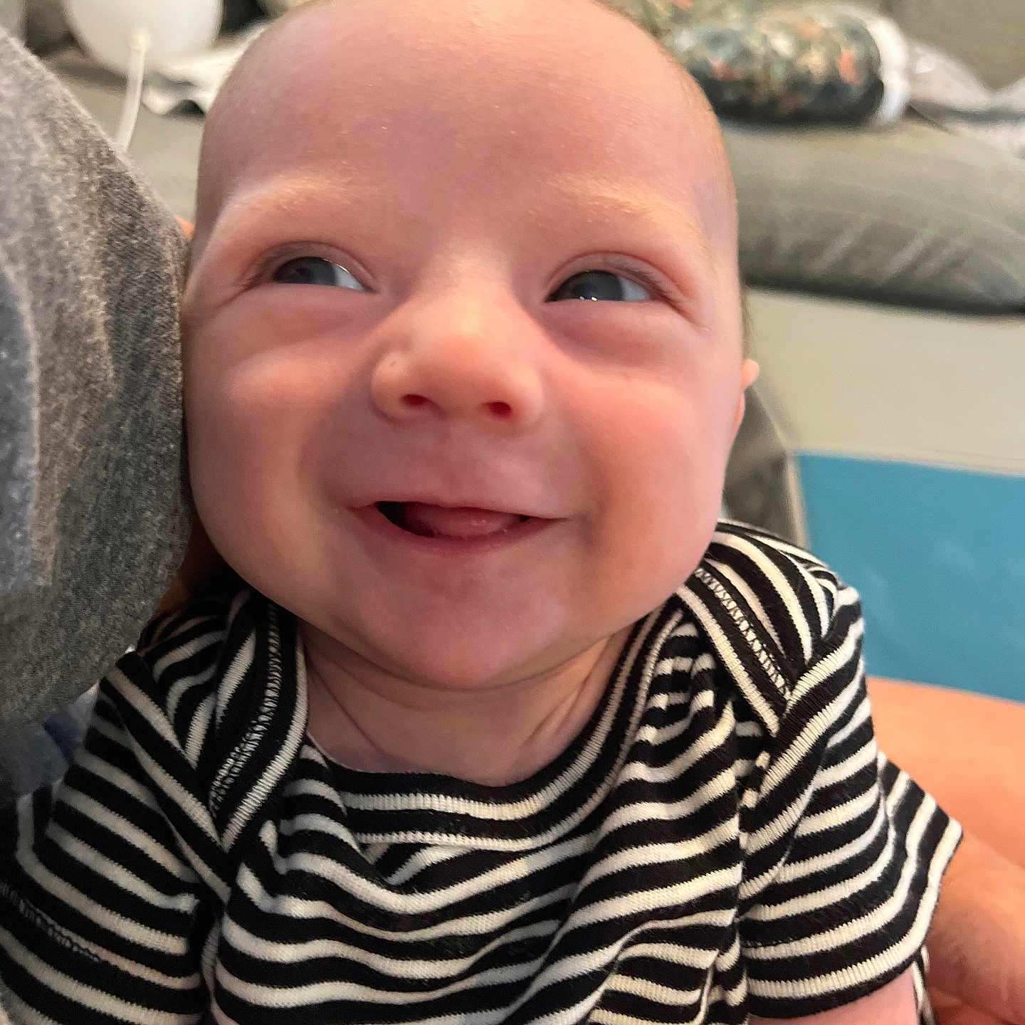 Camden is registered to the contest to win money with this photo: baby, babylaughing, blonde, couch, cushion, face, furniture, hair, happy, head, homedecor, laughing, newborn, person, photography, portrait, smile
