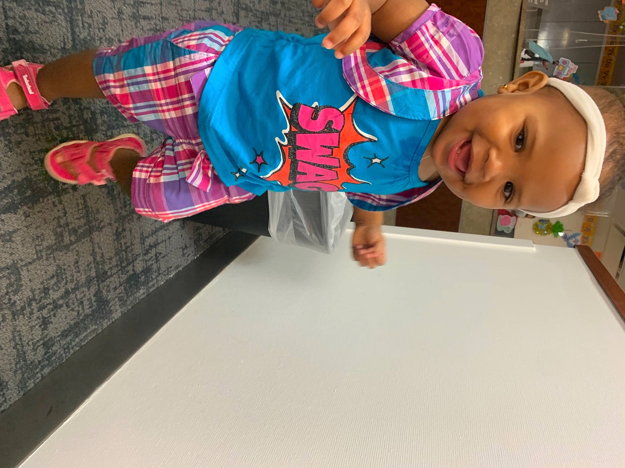 Giselle is registered to the contest to win money with this photo: baby, baby_toddler_clothing, carmine, child, cool, design, flooring, fun, happy, joy, leisure, pattern, person, plaid, play, room, sleeve, smile, t_shirt, tartan