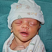 Dante is registered to the contest to win money with this photo: baby, newborn, sleeping, hat, blanket, infant, cute, wrapped, peaceful, closeup, face, skin, child, clothing, headwear, indoors, portrait, resting, soft, cozy