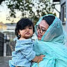 Mahbeer Rahman joined the competition — help win amazing prizes! building, child, daylight, denim_shorts, face, family, fence, glasses, happy, holding, love, outdoor, person, portrait, shawl, smile, striped_shirt, toddler, tree, woman