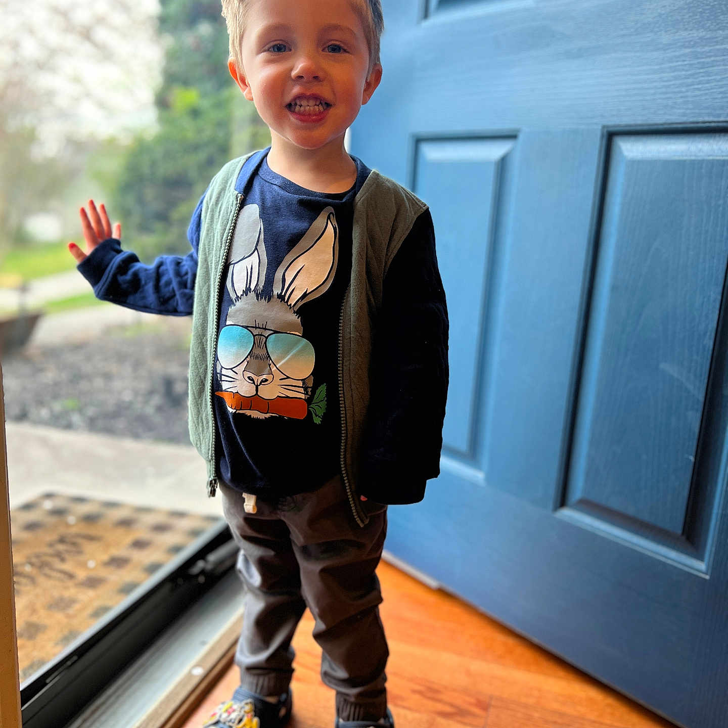 Beckham is registered to the contest to win money with this photo: boy, child, clothing, coat, door, face, footwear, hardwood, head, jacket, jeans, male, pants, person, photography, portrait, shoe, sneaker, walking, wood