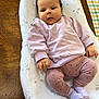 baby, infant, child, lounger, clothing, pink, purple, socks, table, wood, face, hands, legs, pattern, heart, indoor, curious, expression, cute, cozy