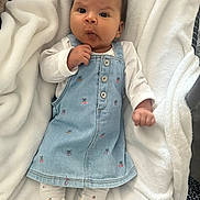 Alyana participe au concours pour gagner de l'argent avec cette photo : baby, infant, child, denim_dress, cherry_pattern, leggings, white_blanket, soft_texture, cute, portrait, indoors, cozy, clothing, sitting, expression, hand, face, person, newborn, comfort