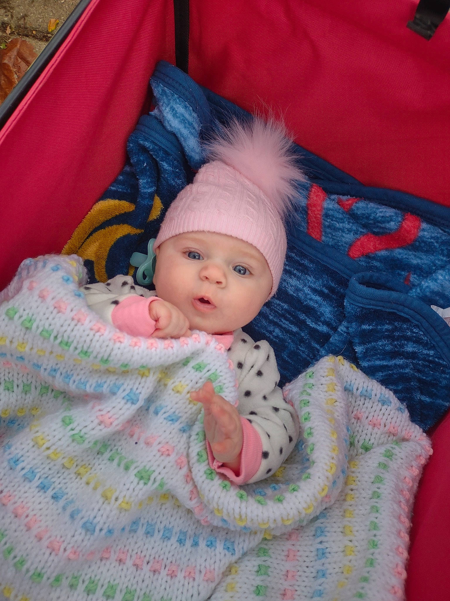 Macelynn is registered to the contest to win money with this photo: baby, baby_products, baby_toddler_clothing, beanie, cap, cheek, child, comfort, costume_hat, eye, head, headwear, knit_cap, linens, magenta, pattern, person, sitting, skin, textile