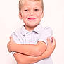 child, boy, smile, arms_crossed, blonde_hair, polo_shirt, light_background, portrait, happy, cute, casual_clothing, young, confident, studio_photo, innocence, face, person, short_sleeves, skin, youth