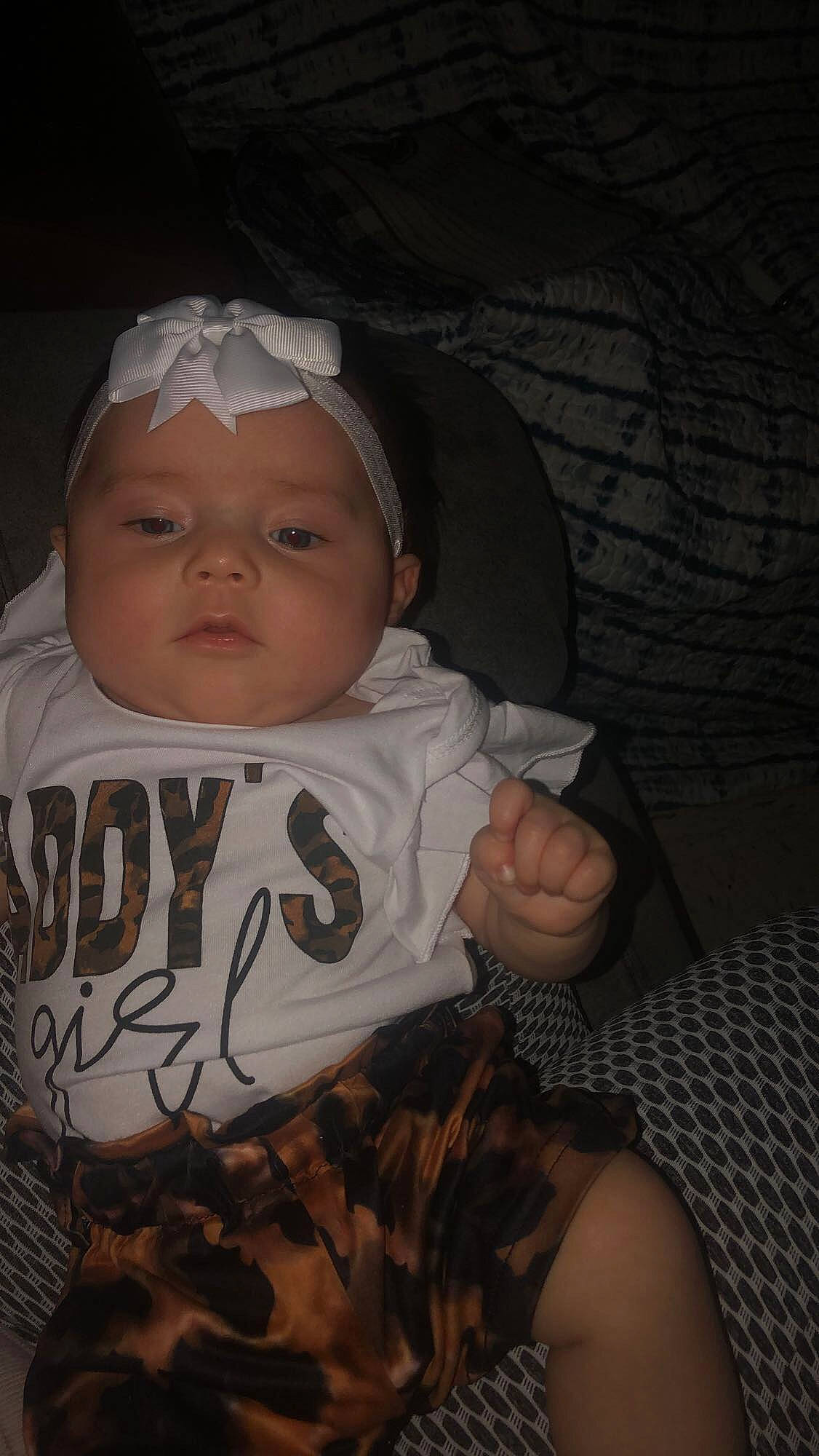 Delilah is registered to the contest to win money with this photo: baby, baby_toddler_clothing, brown, cheek, child, chin, comfort, eyebrow, flash_photography, fun, happy, headgear, headwear, human_body, iris, mouth, nose, person, sitting, skin