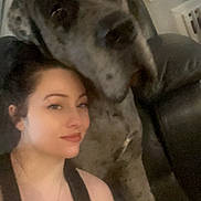 Clyde joined the competition — help win amazing prizes! woman, dog, selfie, indoor, couch, pet, companion, closeup, portrait, casual, home, furniture, relaxed, friendship, black_top, necklace, blinds, large_dog, seated, affection