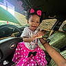 toddler, child, smile, happy, car, steering_wheel, pink_skirt, polka_dots, headband, bow, snack, hand, seat, green_car_seat, interior, portrait, cute, clothing, birthday_shirt, fun