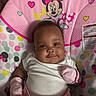 baby, infant, smile, mittens, white_clothing, pink, minnie_mouse, baby_seat, pattern, dots, hearts, cute, child, portrait, indoor, happy, face, person, soft_toys, colorful