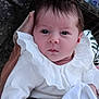 Savannah joined the competition — help win amazing prizes! baby, infant, face, hand, white_clothing, lace_collar, blanket, wicker_basket, portrait, closeup, curious_expression, soft_texture, newborn, person, cute, indoors, holding, skin, head, eyes