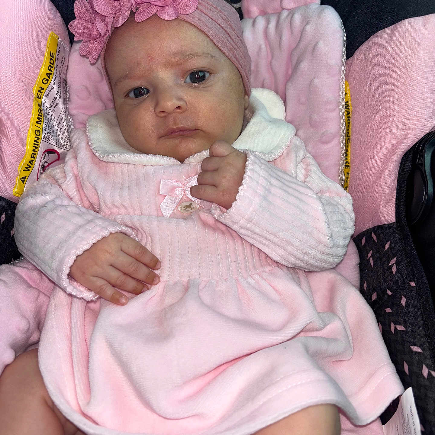 Adara Rose is registered to the contest to win money with this photo: baby, car_seat, child, comfort, cute, expression, fabric, face, flower_accessory, hand, headband, indoors, infant, newborn, person, pink_clothing, portrait, seatbelt, skin, soft_texture