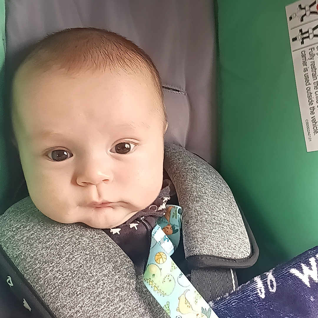 Nathaniel is registered to the contest to win money with this photo: baby, blanket, bodypart, couch, crib, cushion, cutlery, eating, face, finger, food, furniture, hand, head, homedecor, newborn, person, photography, portrait, spoon