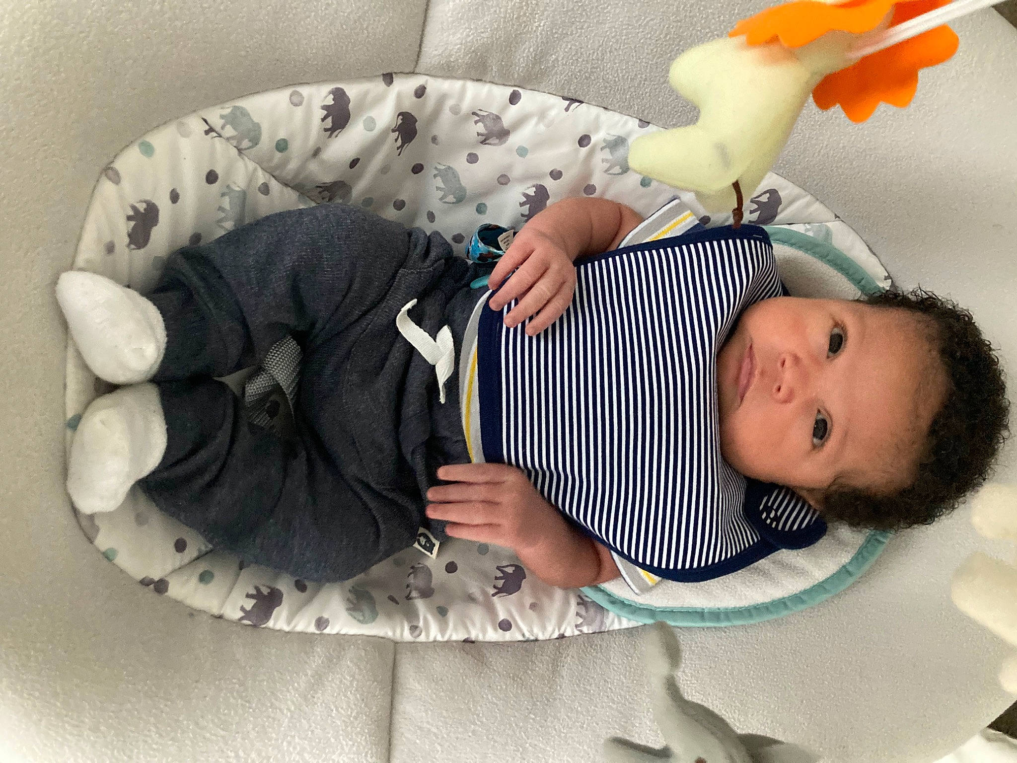 Amaris is registered to the contest to win money with this photo: baby, baby_products, baby_sleeping, baby_toddler_clothing, child, comfort, fashion_accessory, finger, gesture, happy, head, human_body, infant_bed, leg, person, room, sitting, sleeve, stuffed_toy, toddler