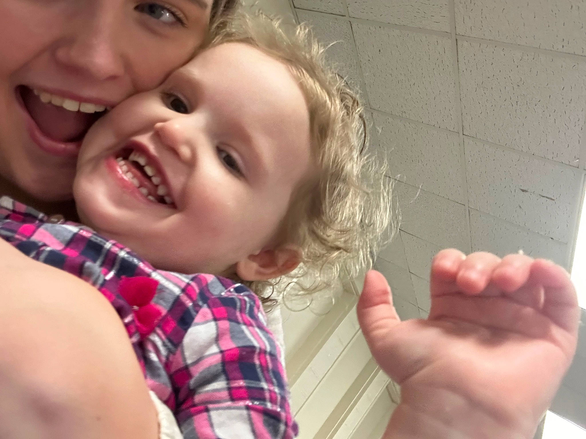 Marlena is registered to the contest to win money with this photo: arm, cheek, child, facial_expression, finger, gesture, hand, happy, human_body, joy, lip, mouth, muscle, nose, person, plaid, skin, smile, tartan, thumb