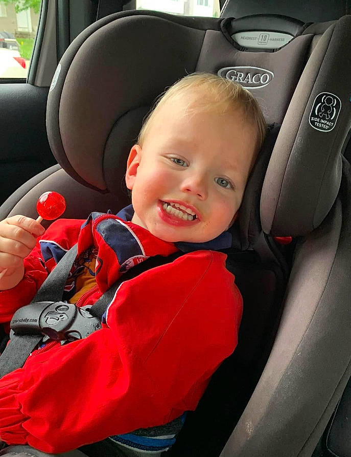 Damon is registered to the contest to win money with this photo: auto_part, automotive_design, automotive_exterior, car, car_seat, car_seat_cover, comfort, head_restraint, joy, mode_of_transport, motor_vehicle, person, personal_luxury_car, plant, product, seat_belt, smile, steering_part, steering_wheel, toddler