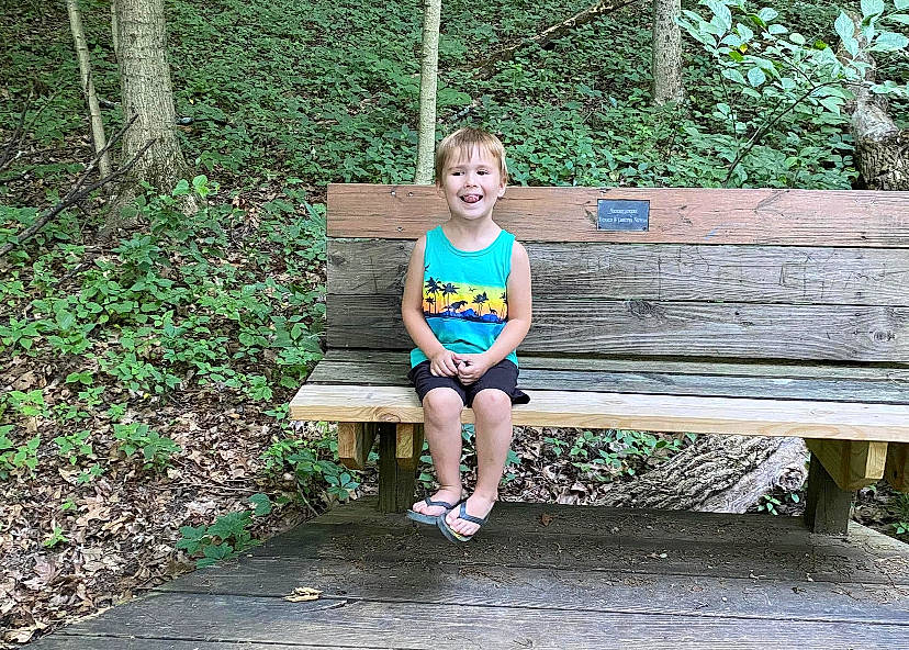 Elijah joined the competition — help win amazing prizes! body_of_water, botany, grass, grass_family, green, happy, joy, leisure, mammal, nature, outdoor_bench, people_in_nature, person, plant, public_space, recreation, smile, standing, thigh, tree