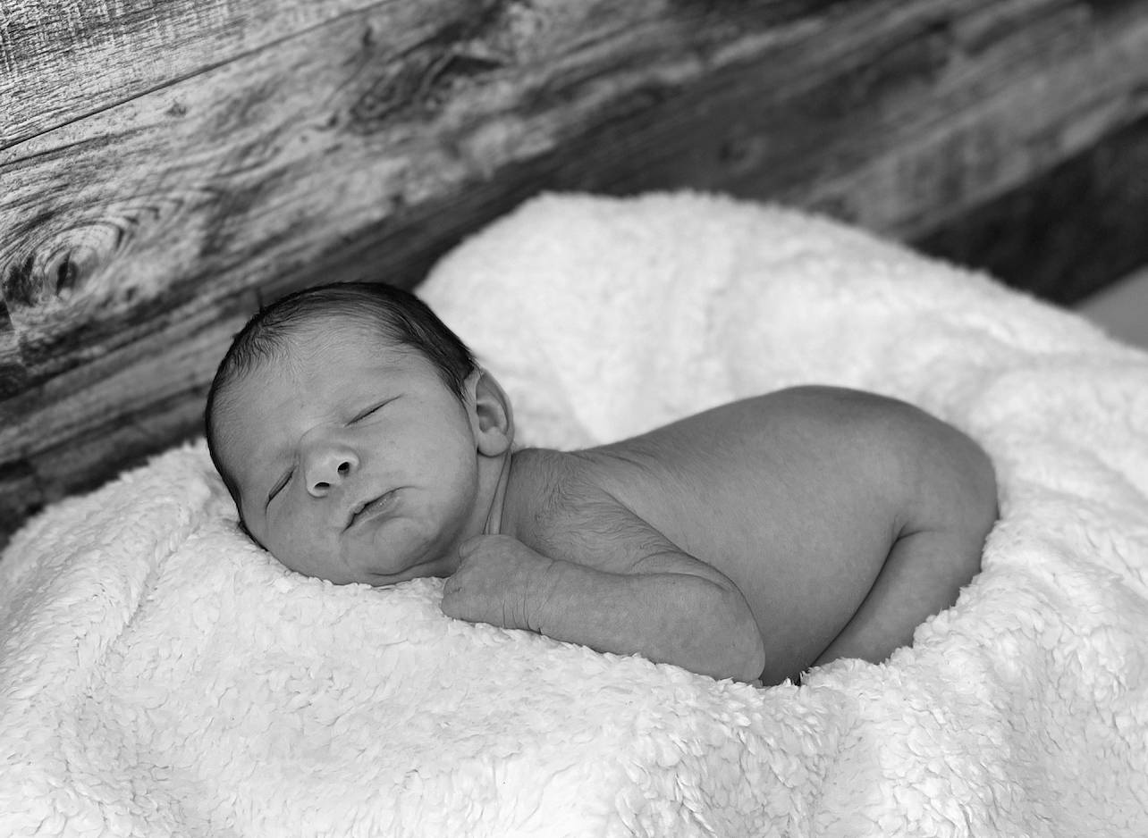 Weston is registered to the contest to win money with this photo: baby, bedtime, cheek, child, comfort, eye, eyebrow, face, flash_photography, fur, happy, head, iris, linens, monochrome, monochrome_photography, nose, person, skin, toddler